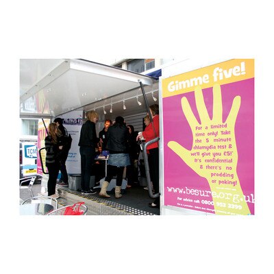 Health Trailer, health messages and testing group of young people interacting inside trailer large posters, Health Edco, 37500